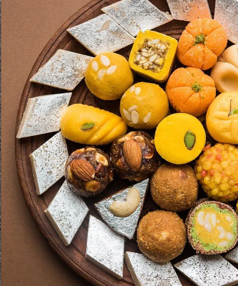 Platter of kaju katli, laddoos and assorted barfi